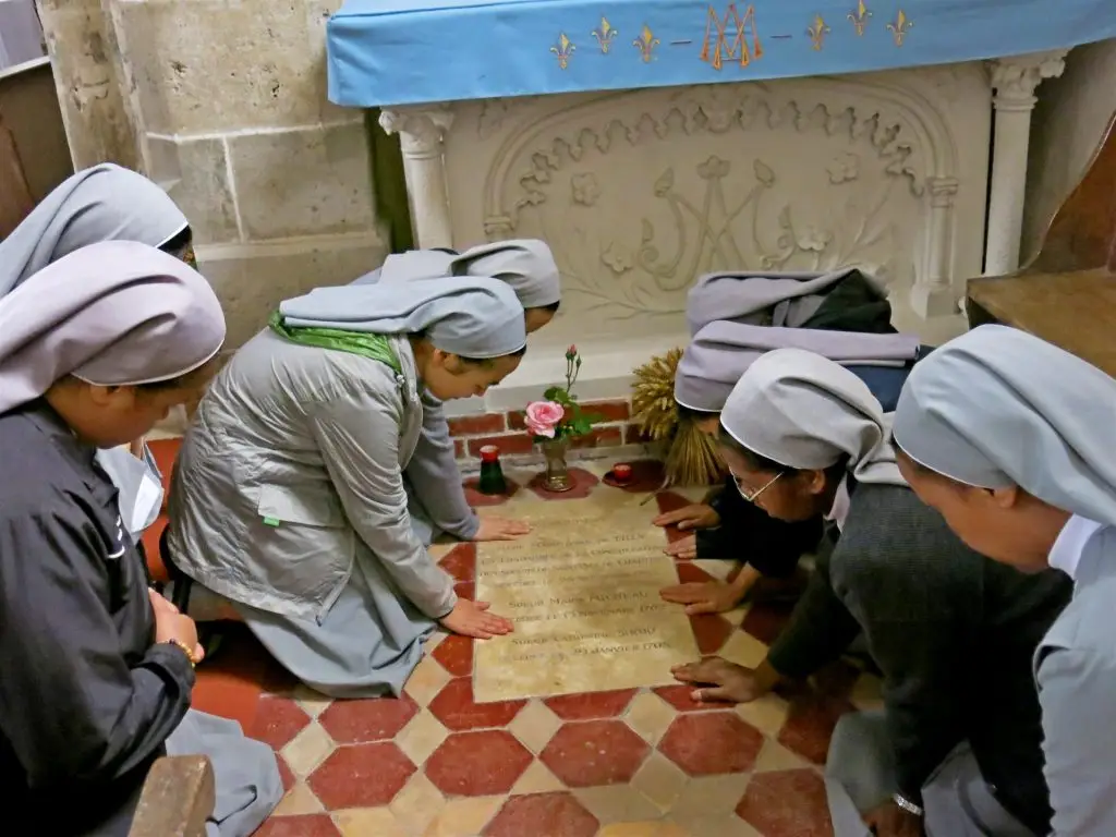 Praying at the tomb of Mother Marie Anne de Tilly